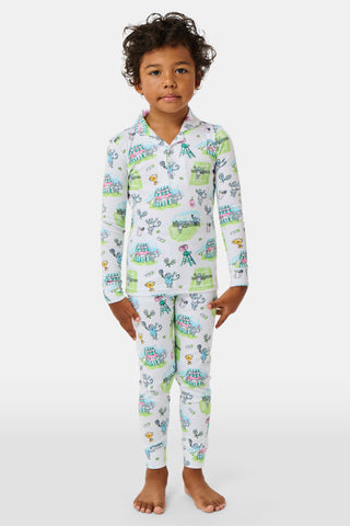The Roller Rabbit Kids Game, Set, Monkey Parker Polo Pajamas feature a playful print of mice, tents, and trees on a white background. Made from soft pima cotton, this pajama set includes a long-sleeve button-up top and matching pants for children.