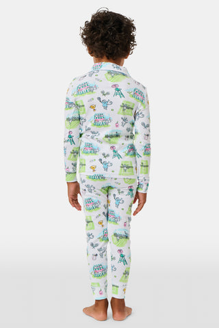 The Roller Rabbit Kids Game, Set, Monkey Parker Polo Pajamas feature a playful print of mice, tents, and trees on a white background. Made from soft pima cotton, this pajama set includes a long-sleeve button-up top and matching pants for children.