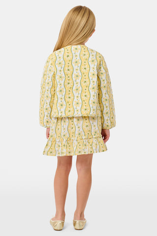 A young girl wearing a Roller Rabbit Kids Lillian Floral Stripe Finn Jacket paired with a matching ruffled skirt and gold ballet flats, standing and smiling against a plain white background—perfect for back-to-school style.