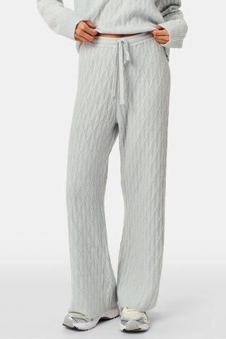 A person wearing the Roller Rabbit Cable Knots Olivia Pant in light gray, featuring a drawstring waist, paired with a matching top and white sneakers. The photo is cropped from shoulders down against a white background.