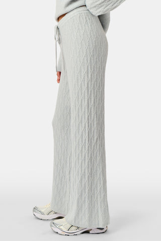 A person wearing the Roller Rabbit Cable Knots Olivia Pant in light gray, featuring a drawstring waist, paired with a matching top and white sneakers. The photo is cropped from shoulders down against a white background.