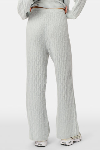 A person wearing the Roller Rabbit Cable Knots Olivia Pant in light gray, featuring a drawstring waist, paired with a matching top and white sneakers. The photo is cropped from shoulders down against a white background.