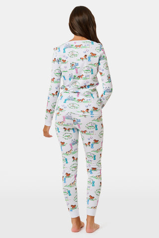 Introducing the Kids Saddle Up Pajamas by Roller Rabbit—a children’s pajama set crafted from premium Pima cotton, featuring a whimsical equestrian print of horses, castles, and greenery on a white background. This high-quality set includes a long-sleeve top and matching pants.