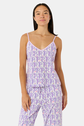 A woman smiles while wearing the TEXPIMA Get Ready With Me Blake Robe, featuring a knee-length cut and a purple and pink paisley pattern, tied at the waist, against a plain white background.