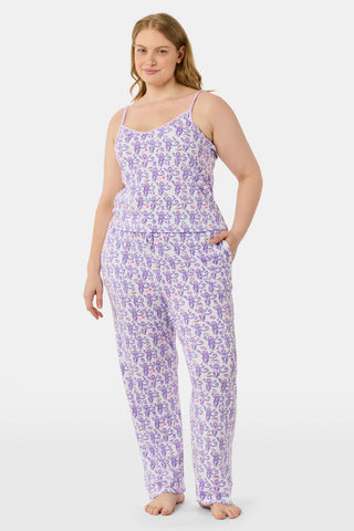 A woman smiles while wearing the TEXPIMA Get Ready With Me Blake Robe, featuring a knee-length cut and a purple and pink paisley pattern, tied at the waist, against a plain white background.