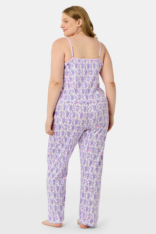 A woman smiles while wearing the TEXPIMA Get Ready With Me Blake Robe, featuring a knee-length cut and a purple and pink paisley pattern, tied at the waist, against a plain white background.