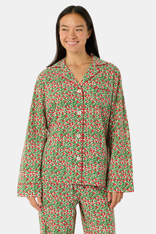 A Holly Berry Napkin Set Of 4 featuring a red berry and green leaf pattern with red-and-white striped borders.