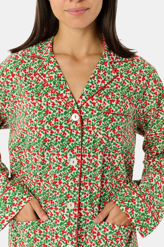 A Holly Berry Napkin Set Of 4 featuring a red berry and green leaf pattern with red-and-white striped borders.