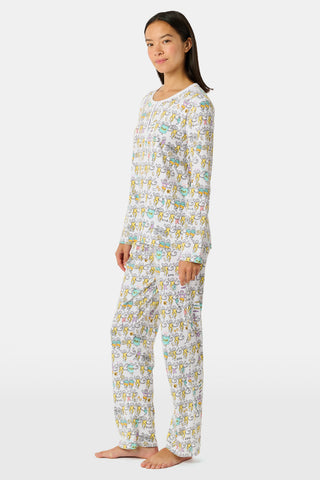 The Roller Rabbit Kappa Alpha Theta Monkey Pajamas set features a white, long-sleeved buttoned top and matching pants, both adorned with a vibrant all-over cartoon print of playful animal characters, including cheerful monkeys.