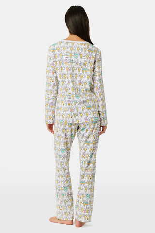 The Roller Rabbit Kappa Alpha Theta Monkey Pajamas set features a white, long-sleeved buttoned top and matching pants, both adorned with a vibrant all-over cartoon print of playful animal characters, including cheerful monkeys.