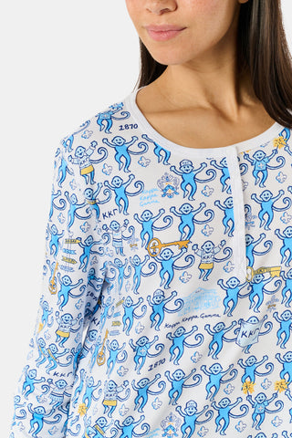 The Roller Rabbit Kappa Kappa Gamma Monkey Pajamas are a two-piece set with long sleeves and pants, showcasing an all-over blue and yellow monkey cartoon print on a white background, displayed on a flat white backdrop.