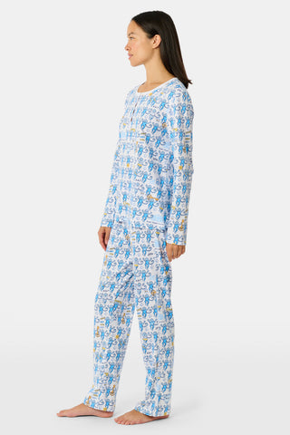 The Roller Rabbit Kappa Kappa Gamma Monkey Pajamas are a two-piece set with long sleeves and pants, showcasing an all-over blue and yellow monkey cartoon print on a white background, displayed on a flat white backdrop.