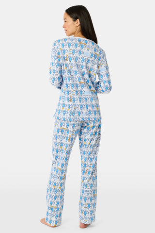 The Roller Rabbit Kappa Kappa Gamma Monkey Pajamas are a two-piece set with long sleeves and pants, showcasing an all-over blue and yellow monkey cartoon print on a white background, displayed on a flat white backdrop.