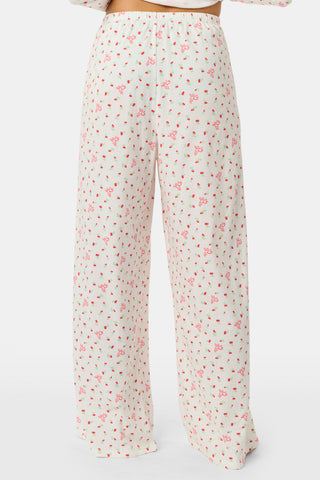 Wearing the Roller Rabbit Mini Monkey Blossom Pointelle Monroe Pant, a person stands barefoot against a plain white background.