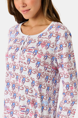 The Roller Rabbit Pi Beta Phi Monkey Pajamas are a long-sleeve set featuring a Henley top and pants, both adorned with a repeating red and blue monkey print on a white background. Made from soft Pima cotton, these pajamas are lightweight and comfortable.
