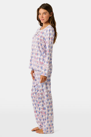 The Roller Rabbit Pi Beta Phi Monkey Pajamas are a long-sleeve set featuring a Henley top and pants, both adorned with a repeating red and blue monkey print on a white background. Made from soft Pima cotton, these pajamas are lightweight and comfortable.