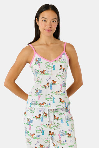 The Saddle Up Joanie Pajamas by Roller Rabbit feature a white sleeveless top and long pants with pink trim. Both pieces are made from soft Pima cotton and decorated with colorful cartoon animal and house prints scattered across the fabric.