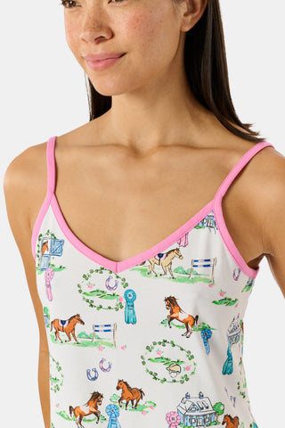 The Saddle Up Joanie Pajamas by Roller Rabbit feature a white sleeveless top and long pants with pink trim. Both pieces are made from soft Pima cotton and decorated with colorful cartoon animal and house prints scattered across the fabric.