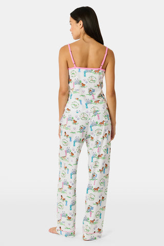 The Saddle Up Joanie Pajamas by Roller Rabbit feature a white sleeveless top and long pants with pink trim. Both pieces are made from soft Pima cotton and decorated with colorful cartoon animal and house prints scattered across the fabric.