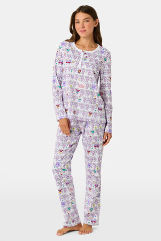 The Sigma Kappa Monkey Pajamas by Roller Rabbit is a long-sleeve set featuring a buttoned top and comfortable elastic waist, decorated with an all-over pattern of colorful cartoon monkey faces on a white background.