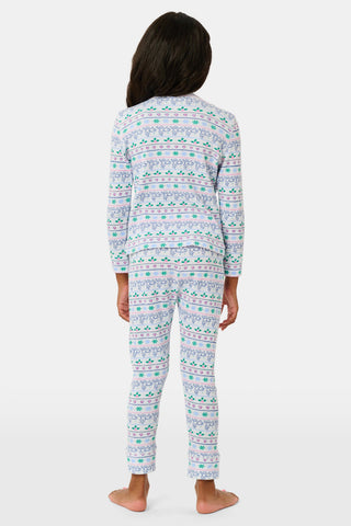 A child wears the SERFLEX Kids Snowday Stripe Iggy Play Set, featuring long sleeves and matching pants with a colorful horizontal stripe pattern of reindeer, snowflakes, and hearts.