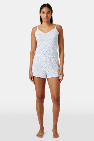 Introducing the Roller Rabbit Mini Monkey Blossom Jones Shortie, a white boxer short featuring a playful pattern of small blue and green turtles and rabbits. Crafted from soft cotton modal for a gentle feel and relaxed fit, this short is showcased against a simple light background.