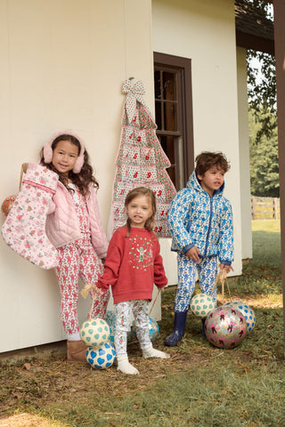 A child wears a blue SOPHISTICA Kids Monkey Reversible Puffer Jacket featuring heart-shaped quilting, a white and light blue chest stripe, and a hood.
