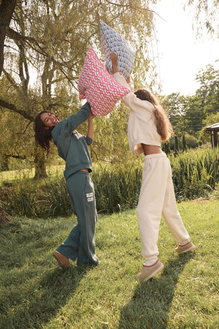 Deep teal wide-leg Sleep Club Mimi Sweatpants in Dream Fleece with an elastic drawstring waist and SLEEP CLUB printed on the right hip.