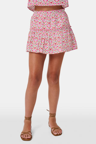 A Roller Rabbit Kids Garden Gate Floral Alexis Skirt with matching briefs, both showcasing a pink, green, and white flower pattern, is displayed on a plain white background. This cotton skirt is ideal for girls who love playful floral prints.
