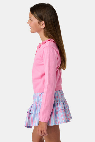 The Kids Ellis Cardigan by Roller Rabbit is a rose pink, long-sleeve cardigan featuring a ruffled collar and pearl-like buttons. Shown flat on a white background, it's made from soft cotton sweater material.