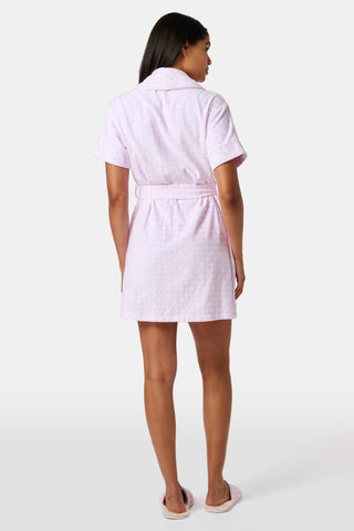 The Roller Rabbit Gingham Hearts Brooks Robe features a light pink gingham pattern with subtle hearts, crafted from soft cotton. This short-sleeve robe includes front pockets and a matching waist tie, and is displayed against a plain white background.