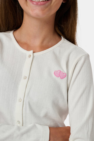 The Roller Rabbit Kids Hearts Pointelle Heidi Cardigan features a white long-sleeve design with playful pink heart details, reminiscent of a classic button-up style, and is displayed against a plain white background.