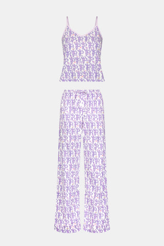 A woman smiles while wearing the TEXPIMA Get Ready With Me Blake Robe, featuring a knee-length cut and a purple and pink paisley pattern, tied at the waist, against a plain white background.