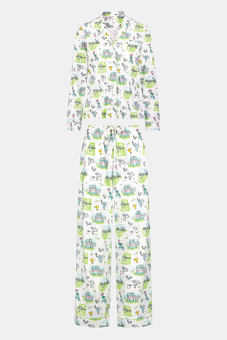Introducing the Game, Set, Monkey Long Sleeve Polo Pajamas by Roller Rabbit—a cozy white pajama set expertly crafted from soft Pima Cotton. The set features a playful Game Set Monkey print with vibrant green, blue, and yellow animal and nature illustrations. Designed with long sleeves, a button-up polo top, and comfortable drawstring waist pants, this delightful set is showcased against a plain light background.
