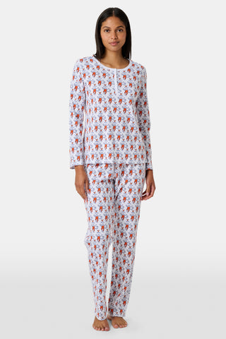 A woman stands barefoot wearing the SERFLEX UVA Lovely Monkey Pajamas—a matching long-sleeved top and pants set crafted from soft Pima cotton, featuring a playful red and white cartoon monkey print on a plain white background. These cozy UVA PJs are perfect dorm essentials for relaxing in comfort.