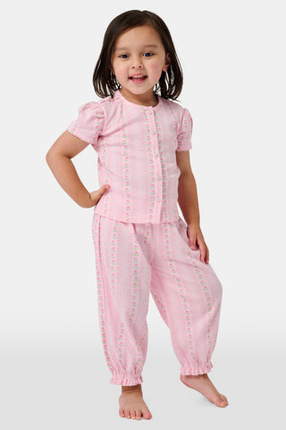 The Kids Daisy Heart Stripe Lucy Pants by Roller Rabbit are crafted from soft Pima cotton genie pant fabric in rose pink, featuring an elastic waistband and cuffs, with a subtle striped pattern and small floral designs throughout—making them a charming addition to girls' fashion.