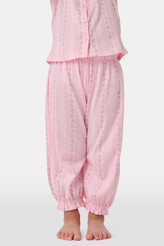 The Kids Daisy Heart Stripe Lucy Pants by Roller Rabbit are crafted from soft Pima cotton genie pant fabric in rose pink, featuring an elastic waistband and cuffs, with a subtle striped pattern and small floral designs throughout—making them a charming addition to girls' fashion.