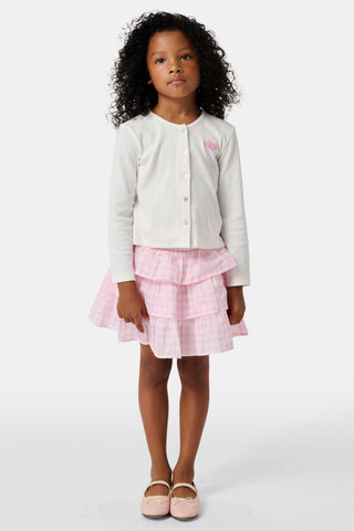 The Roller Rabbit Kids Hearts Pointelle Heidi Cardigan features a white long-sleeve design with playful pink heart details, reminiscent of a classic button-up style, and is displayed against a plain white background.