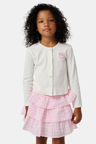 The Roller Rabbit Kids Hearts Pointelle Heidi Cardigan features a white long-sleeve design with playful pink heart details, reminiscent of a classic button-up style, and is displayed against a plain white background.