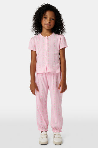 The Kids Daisy Heart Stripe Lucy Pants by Roller Rabbit are crafted from soft Pima cotton genie pant fabric in rose pink, featuring an elastic waistband and cuffs, with a subtle striped pattern and small floral designs throughout—making them a charming addition to girls' fashion.