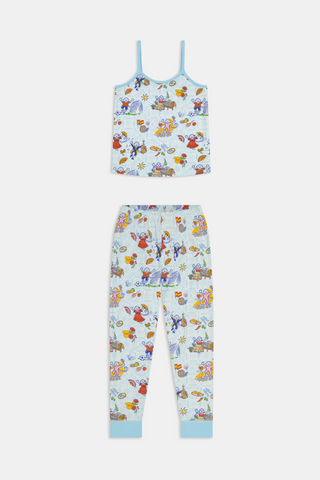 Young child with long brown hair stands barefoot, wearing the Roller Rabbit Kids Spain Monkey Noa Set—light blue Pima cotton loungewear with playful monkey prints and blue trim—against a plain white background.