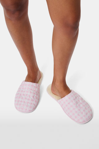 A pair of Roller Rabbit Gingham Hearts Quilted Slippers in pink and white, featuring closed toes and open heels, is displayed on a white background.