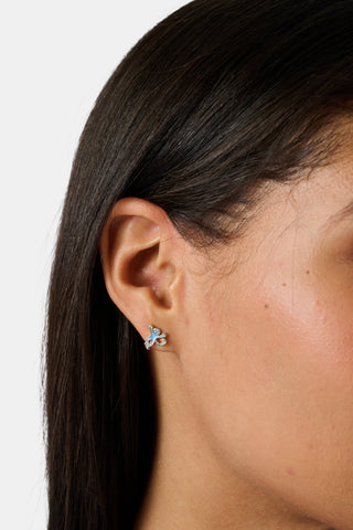 The Roller Rabbit Icon Party Earring Pack includes six pairs of charming gold stud earrings—featuring signature icons like blue monkeys, a crescent moon, a star, whales, and blue elephants—perfect for creating a custom earscape, all beautifully displayed on a plain white background.