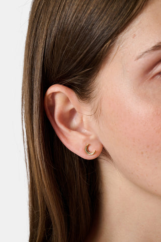 The Roller Rabbit Icon Party Earring Pack includes six pairs of charming gold stud earrings—featuring signature icons like blue monkeys, a crescent moon, a star, whales, and blue elephants—perfect for creating a custom earscape, all beautifully displayed on a plain white background.