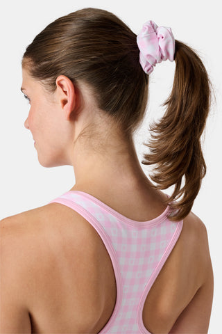 The Roller Rabbit Gingham Hearts Scrunchie Set Of 2 features one pink and white gingham scrunchie with small hearts and one blue and white gingham scrunchie with small hearts, displayed vertically on a plain background.