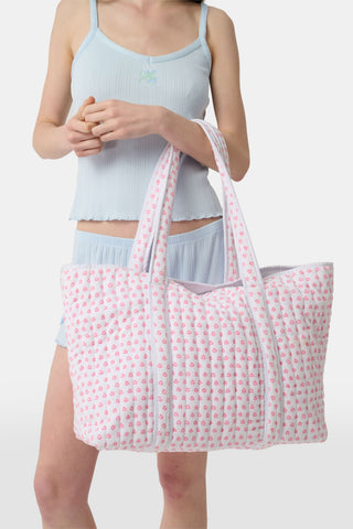 The Roller Rabbit Hearts Terry Beach Tote is a large quilted bag with two handles, featuring a white background and pink heart pattern—ideal for the beach or carrying your daily essentials.