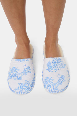 A pair of Sherwood Forest Monkey Quilted Slippers by Roller Rabbit with plush faux-shearling lining and blue floral patterns, displayed side by side on a white background.
