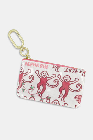 The Alpha Phi Monkey Coin Pouch by Roller Rabbit is a small zippered pouch crafted from water-resistant cotton canvas and features red dancing monkeys, diamonds, and ALPHA PHI text on a white background. It comes with a gold clip for convenience and can be easily wiped clean for care.