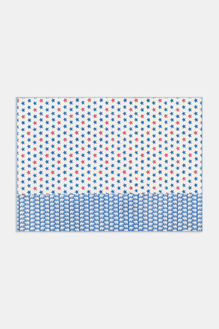 The Liberty Stripe Quilted Flag by JEFF AKSEIZER features a stylized patchwork American flag design, with patterned rows of stars, Xs, and repeating Democratic donkey and Republican elephant icons in red and blue on a white background, reminiscent of Roller Rabbit fabrics.