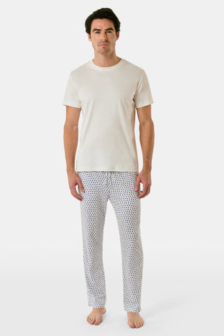The Roller Rabbit Mens Hearts Simon Pant features white pajama pants with a blue dotted pattern, a drawstring waistband, and wide legs, displayed on a plain white background.